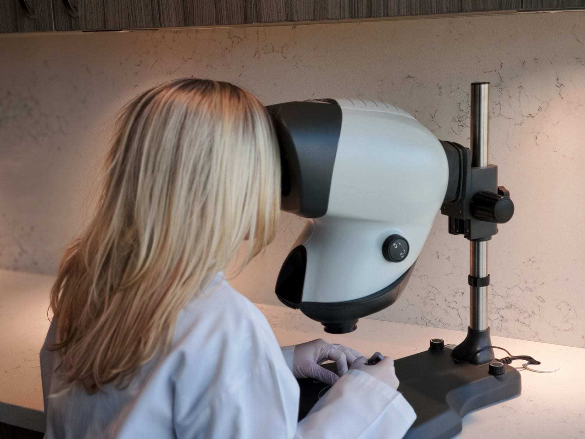 A woman conducting a hair restoration procedure