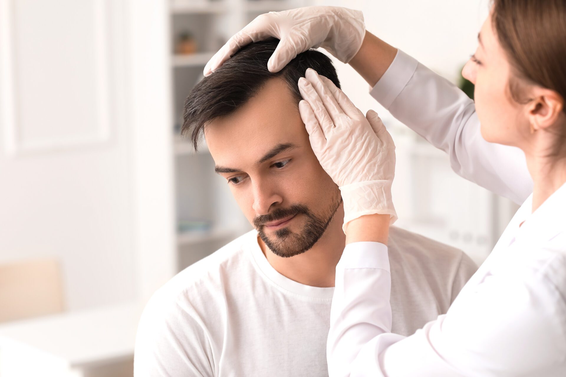 Man receiving an FUE hair transplant consultation from medical professional